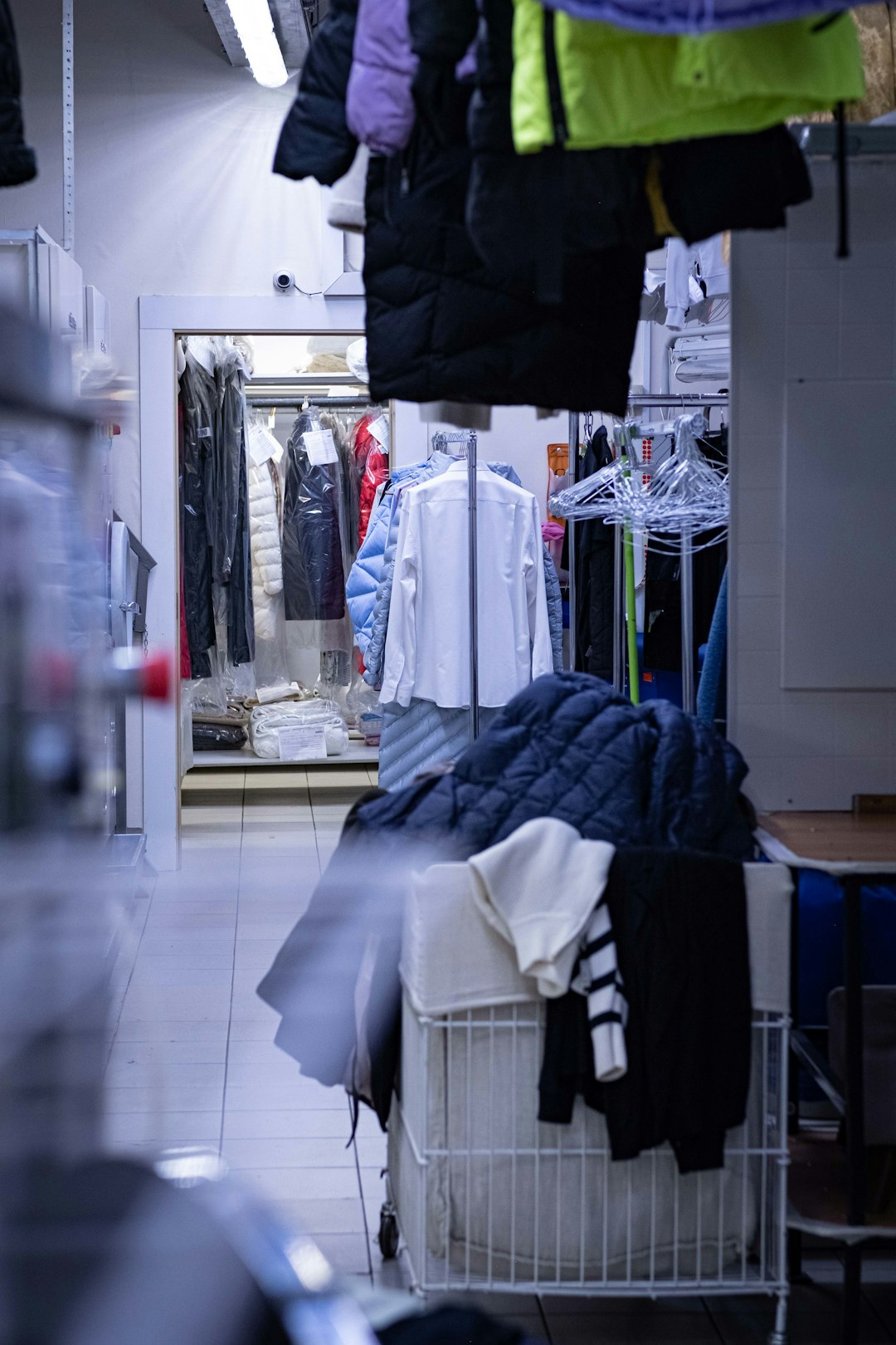 a-clothing-store-with-clothes-hanging-on-racks-jjfepx0egau